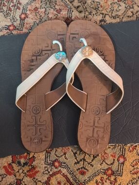 Tory Burch Brown Footbed Flip Flops with Cream Straps and Gold Logo
